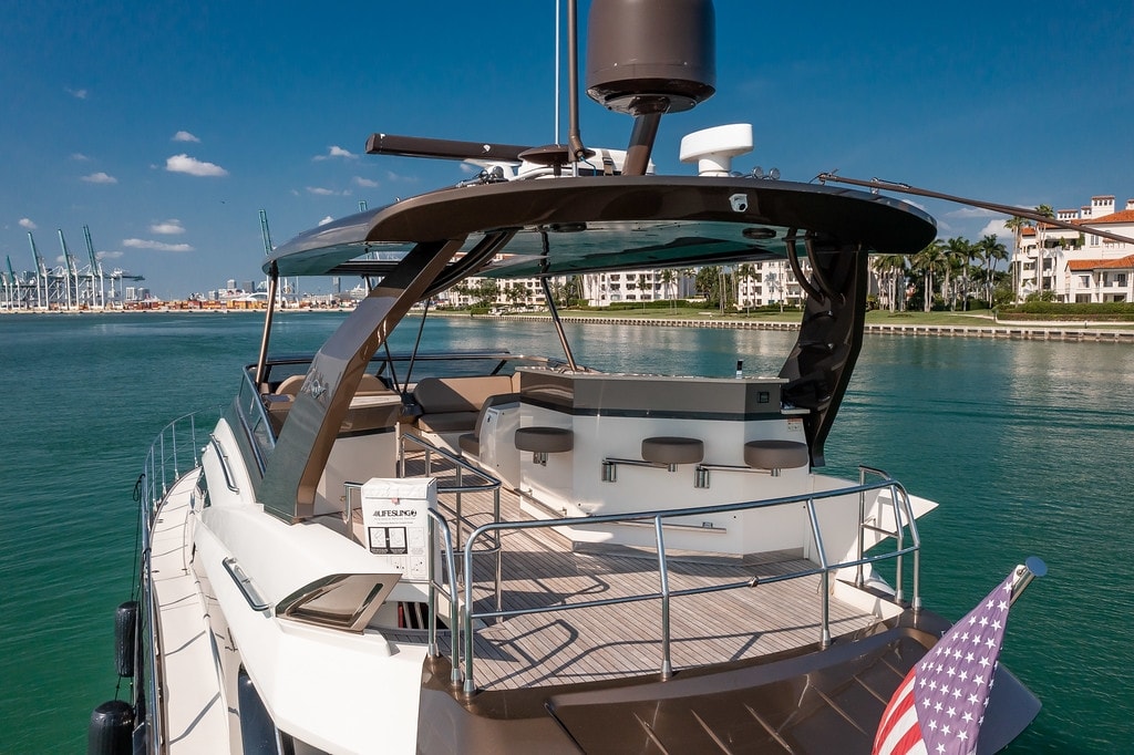 Marquis 66' on the water with waterfront mansions in the background