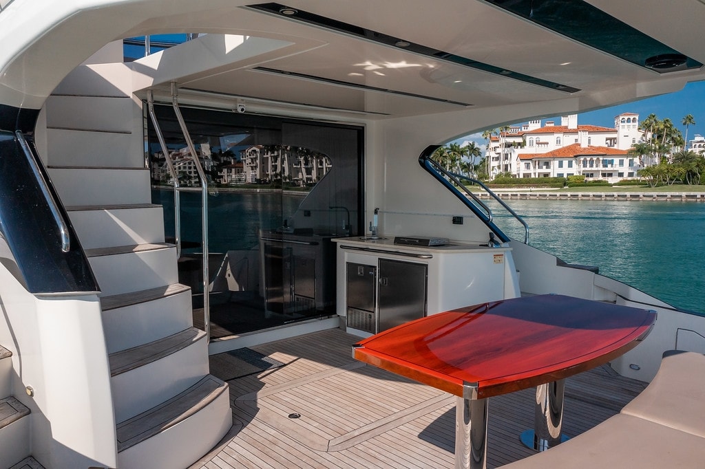 Marquis 66' flybridge dining table under the open bimini with the Miami skyline