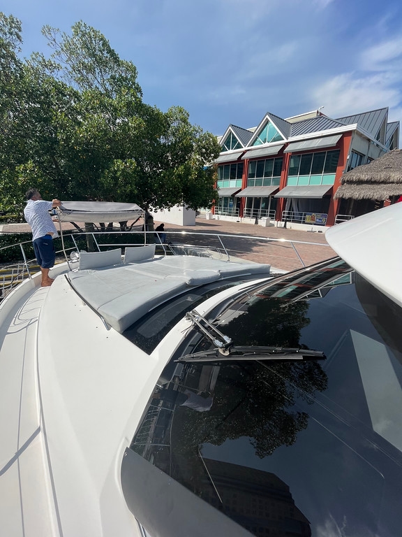 Crew preparing the bow of the Prestige 68' at the marina dock